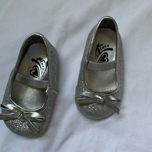 Silver sparkly 0-3 month shoes. Elastic strap, soft sole, bow detail